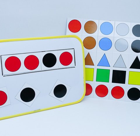A sheet of magnets and a whiteboard with them in use.