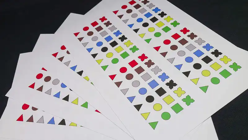 Figurenotes Stickers sheets fanned out on a black surface